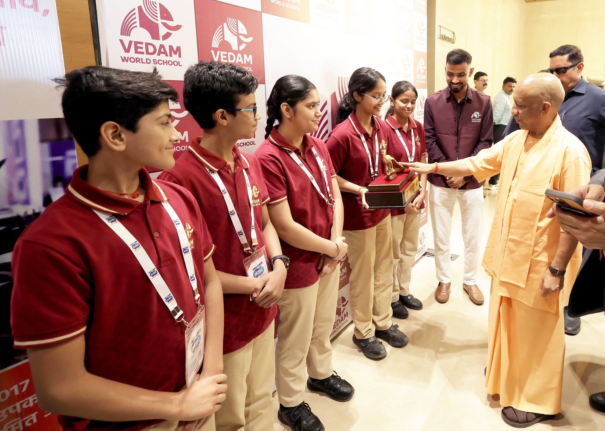 Hon'ble Chief Minister Yogi Adityanath presenting an award to Vedam students at the Amar Ujala Foundation Day programme