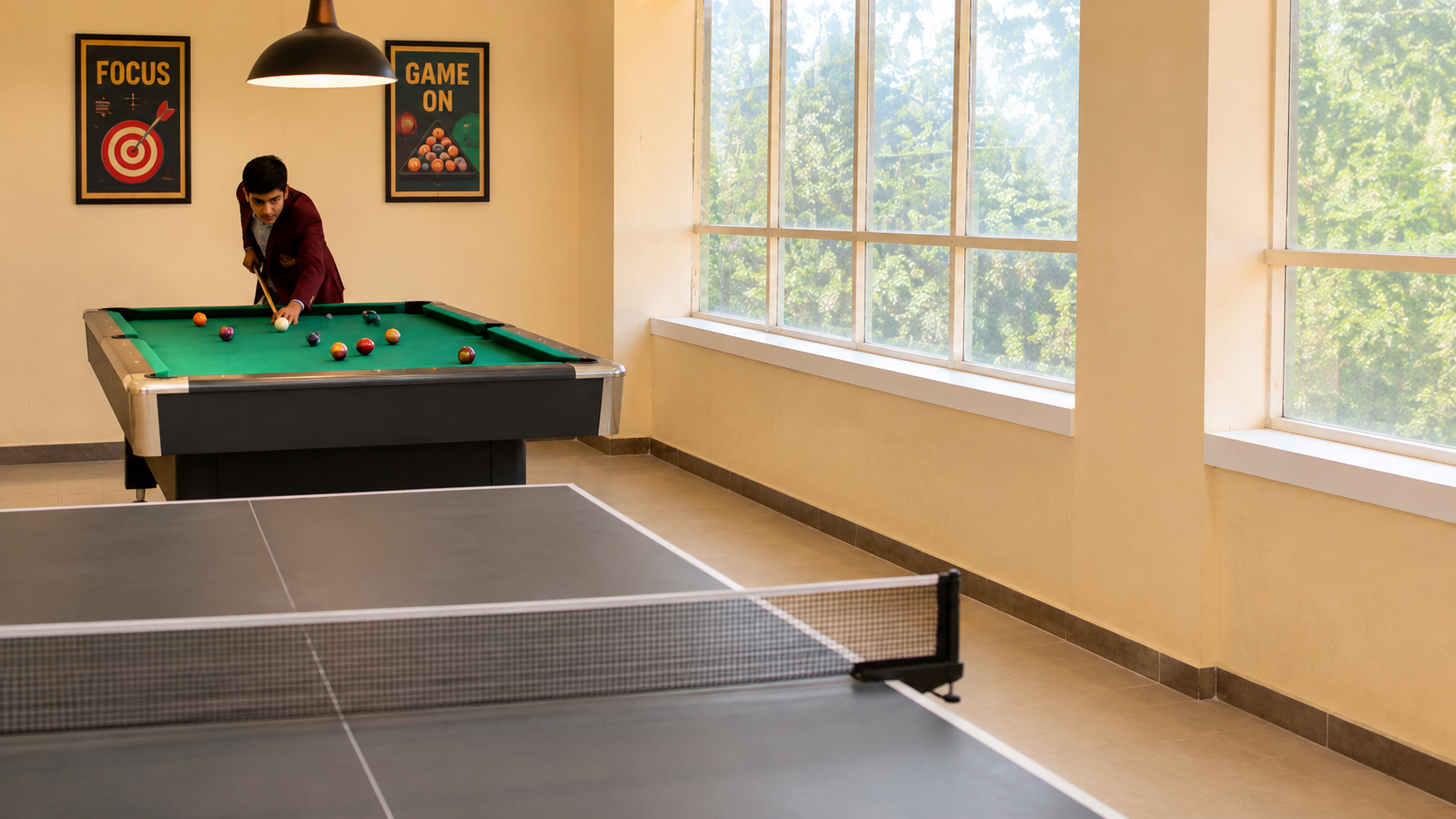 Student playing snooker beside a table tennis table in the games lounge — Ayodhya Road campus, VEDAM World School